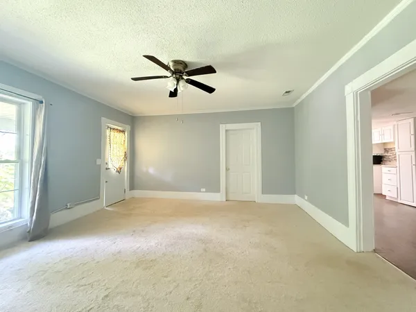 a view of a big room with windows and cabinet