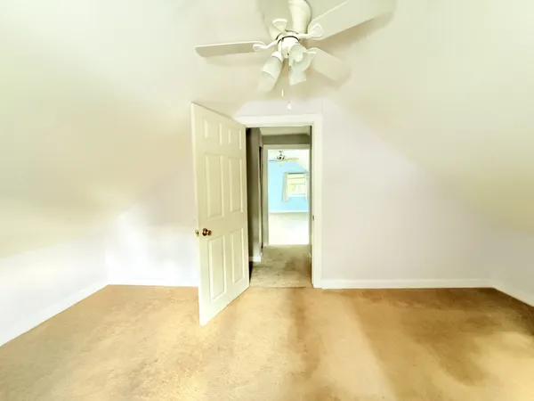 a view of a big room with a chandelier fan
