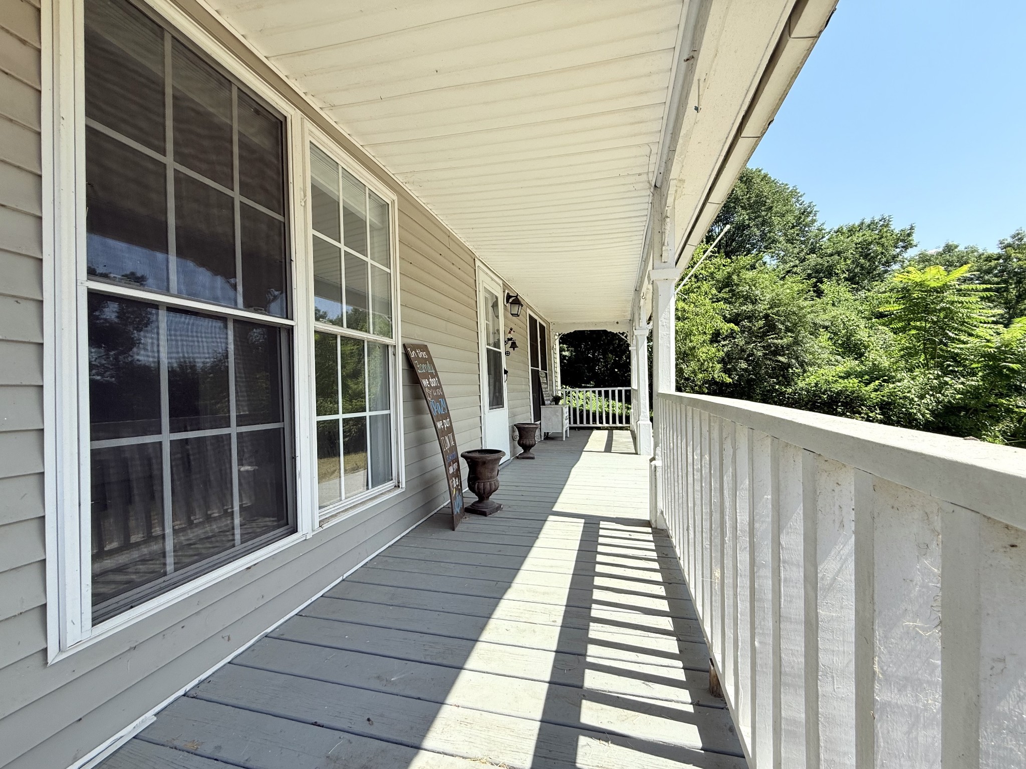 2844 Jarman Hollow Road Palmyra, TN 37142 - Photo 3 of 32 a view of balcony with wooden floor and seating space