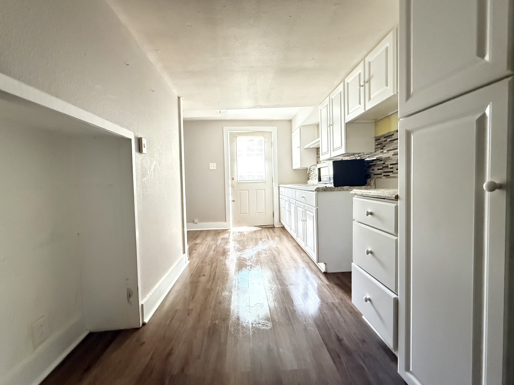 2844 Jarman Hollow Road Palmyra, TN 37142 - Photo 7 of 32 a kitchen with a refrigerator a stove top oven and wooden floor
