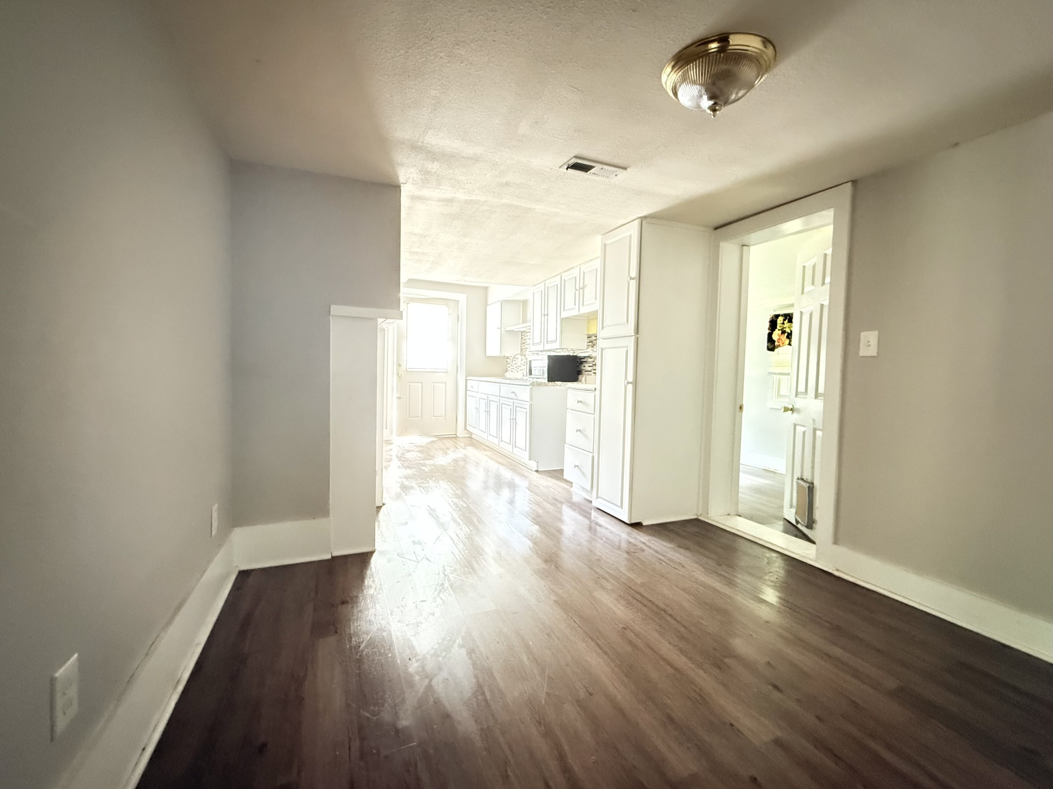 2844 Jarman Hollow Road Palmyra, TN 37142 - Photo 10 of 32 an empty room with wooden floor and windows