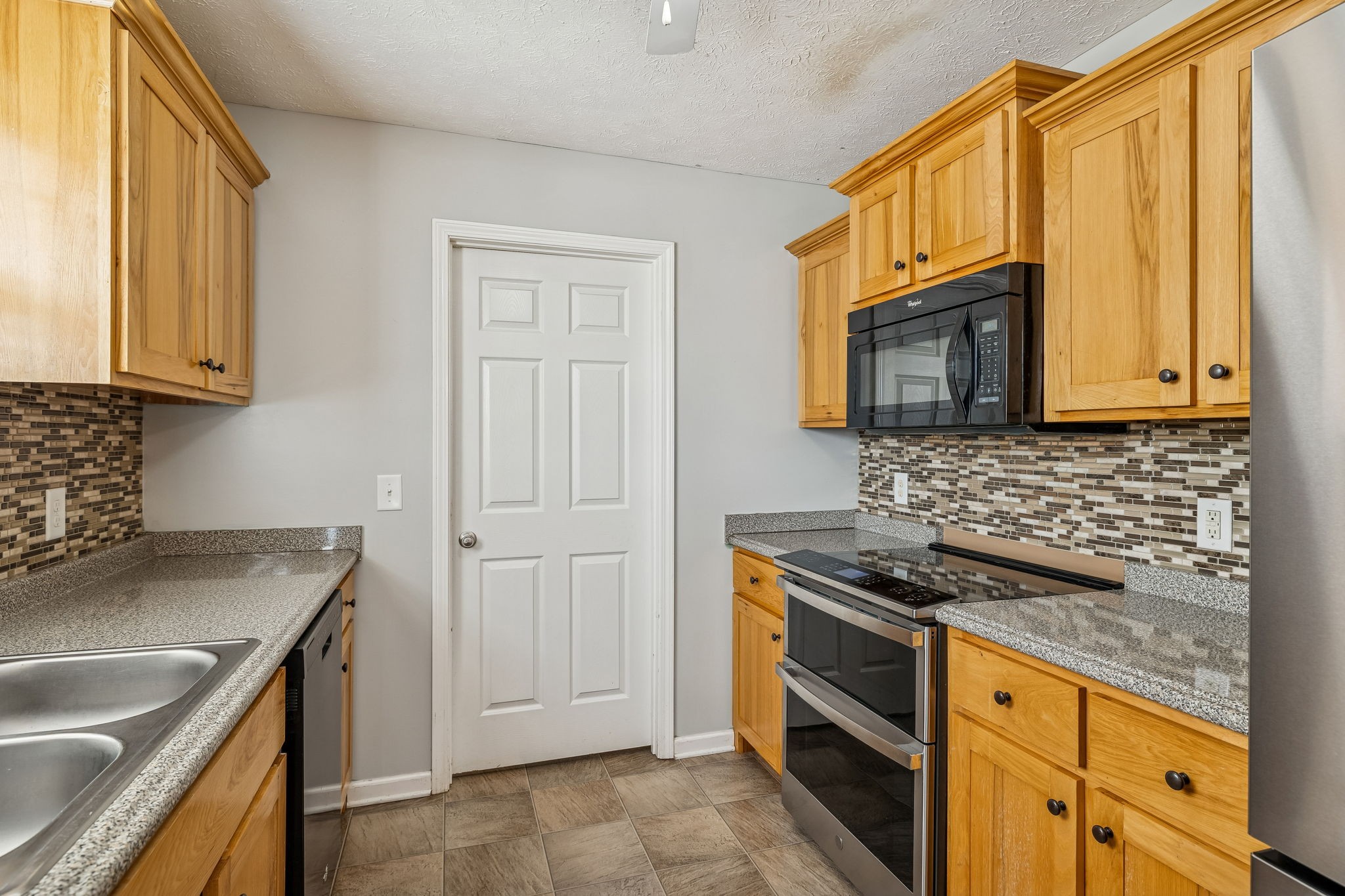 136 Thacker Drive Portland, TN 37148 - Photo 11 of 39 a kitchen with stainless steel appliances granite countertop a sink stove and microwave