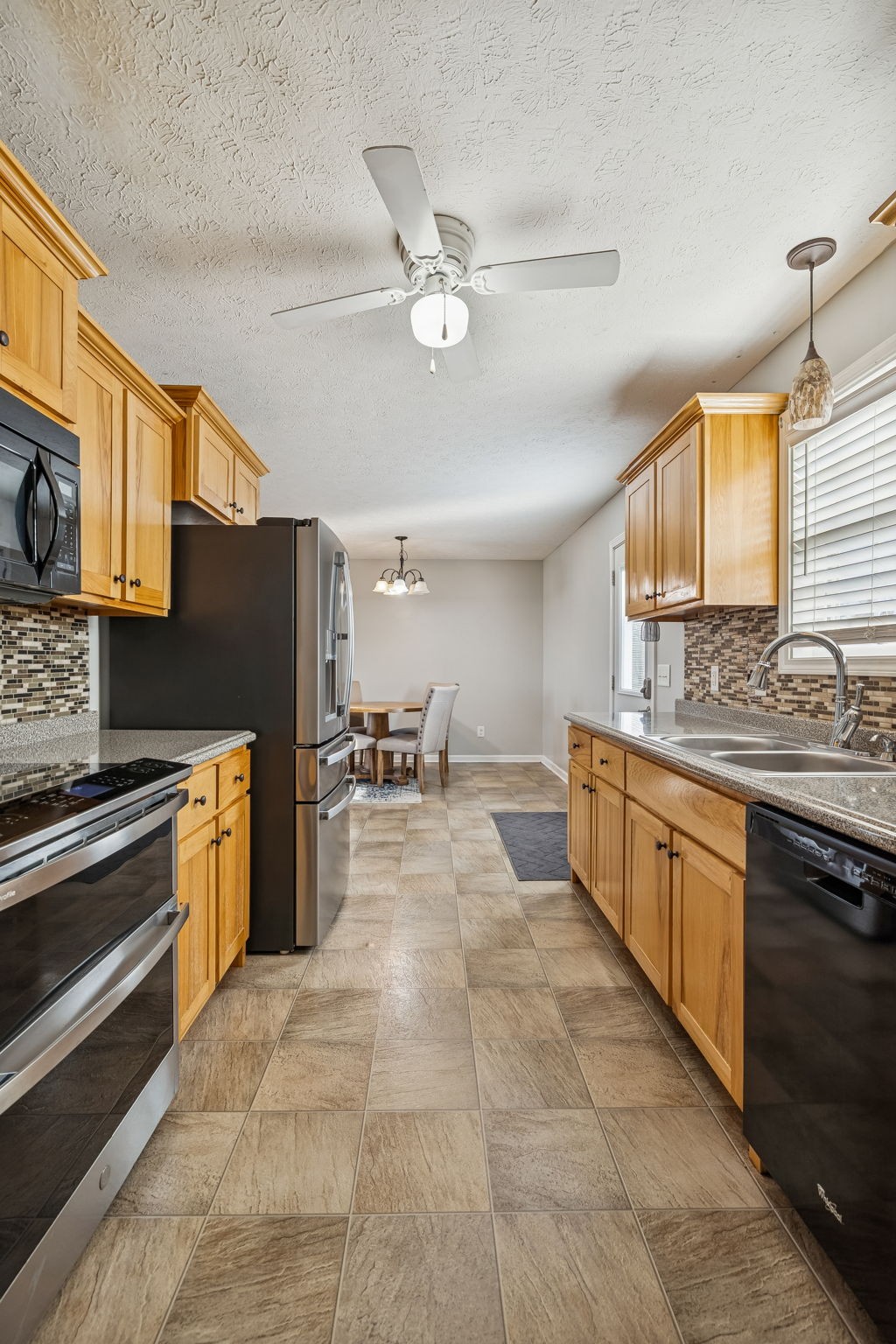 136 Thacker Drive Portland, TN 37148 - Photo 13 of 39 a large kitchen with a large window cabinets and stainless steel appliances