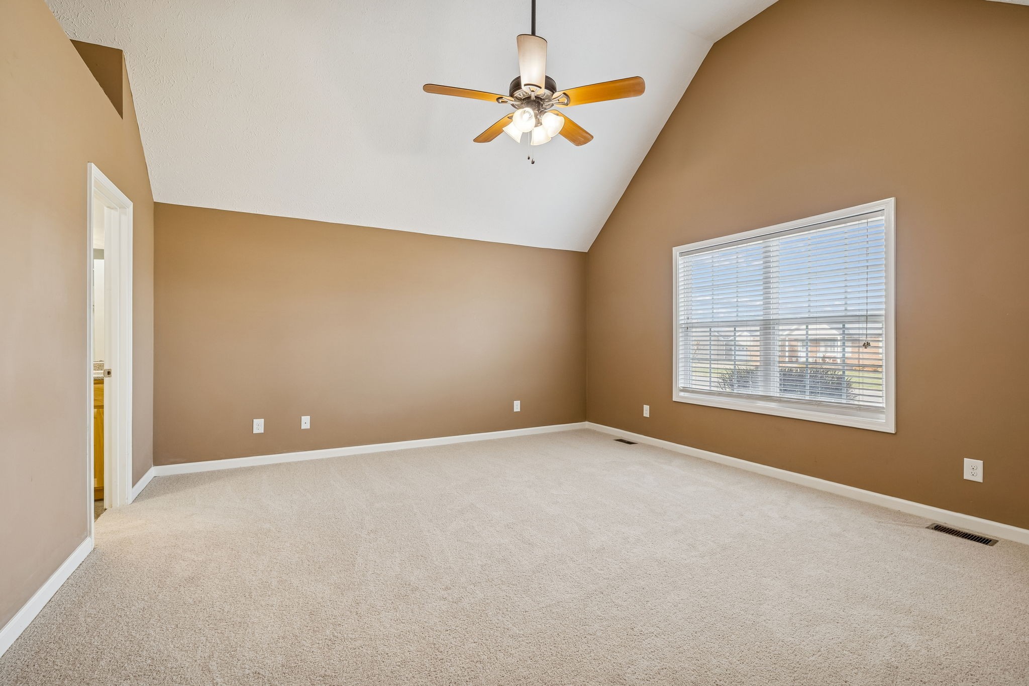 136 Thacker Drive Portland, TN 37148 - Photo 14 of 39 an empty room with a window and a ceiling fan
