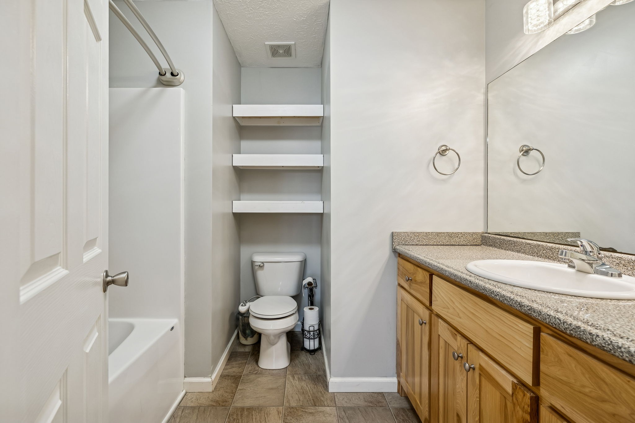 136 Thacker Drive Portland, TN 37148 - Photo 17 of 39 a bathroom with a granite countertop sink a toilet and bathtub