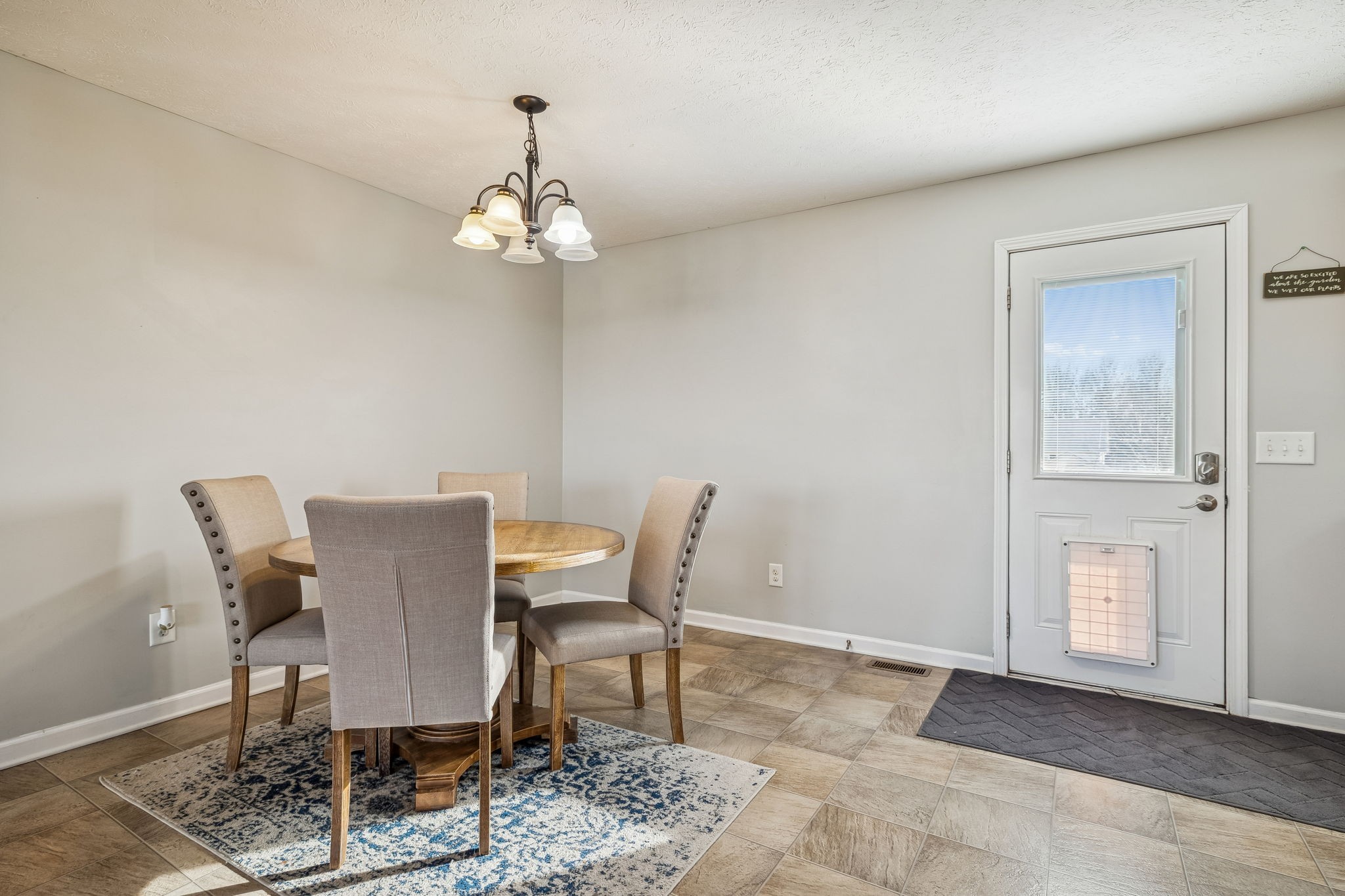 136 Thacker Drive Portland, TN 37148 - Photo 8 of 39 a view of a dining room with furniture wooden floor and a chandelier