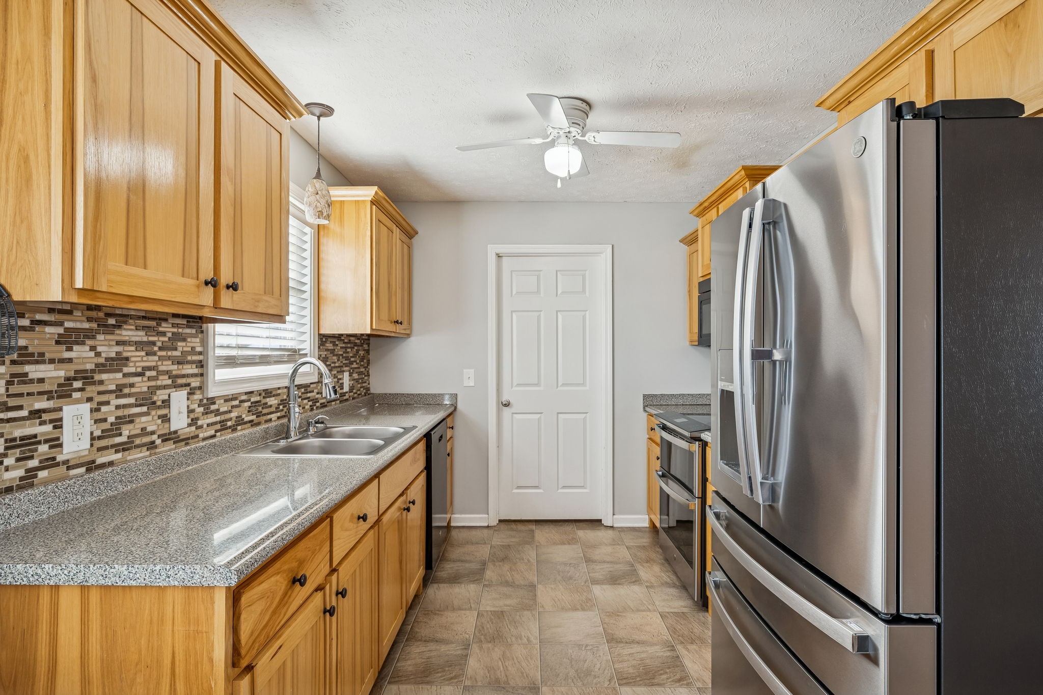 136 Thacker Drive Portland, TN 37148 - Photo 9 of 39 a kitchen with stainless steel appliances granite countertop a refrigerator and a sink