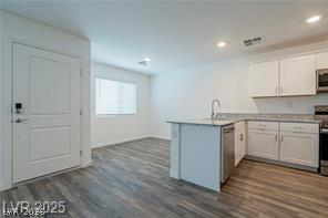 12347 Indigo Montage Road, Unit 3 Las Vegas, NV 89183 - Photo 6 of 23 Clean lines and wood-look flooring extend through the open concept kitchen and living space.