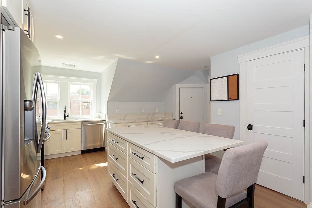 79 Robert Street, Unit 3 Boston, MA 02131 - Photo 12 of 20 a kitchen that has a table and chairs in it