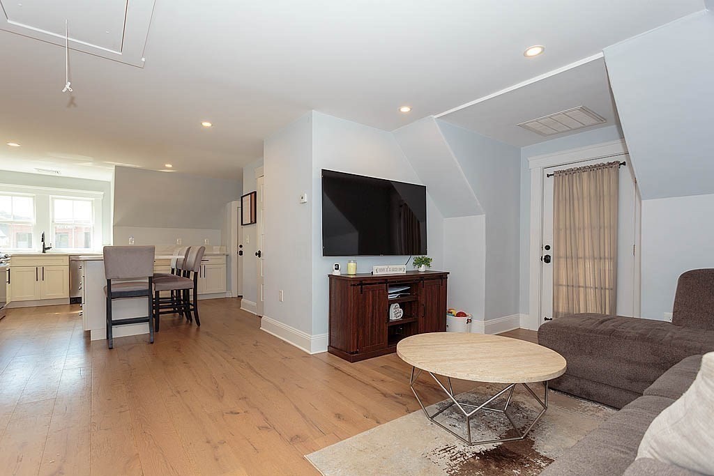 79 Robert Street, Unit 3 Boston, MA 02131 - Photo 13 of 20 a living room with furniture and a flat screen tv
