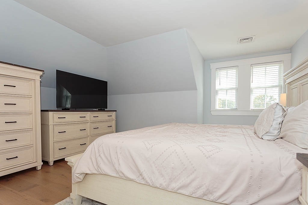 79 Robert Street, Unit 3 Boston, MA 02131 - Photo 16 of 20 a bedroom with a bed and flat screen tv
