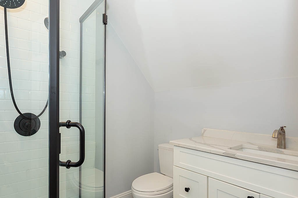 79 Robert Street, Unit 3 Boston, MA 02131 - Photo 19 of 20 a bathroom with a granite countertop toilet and a sink