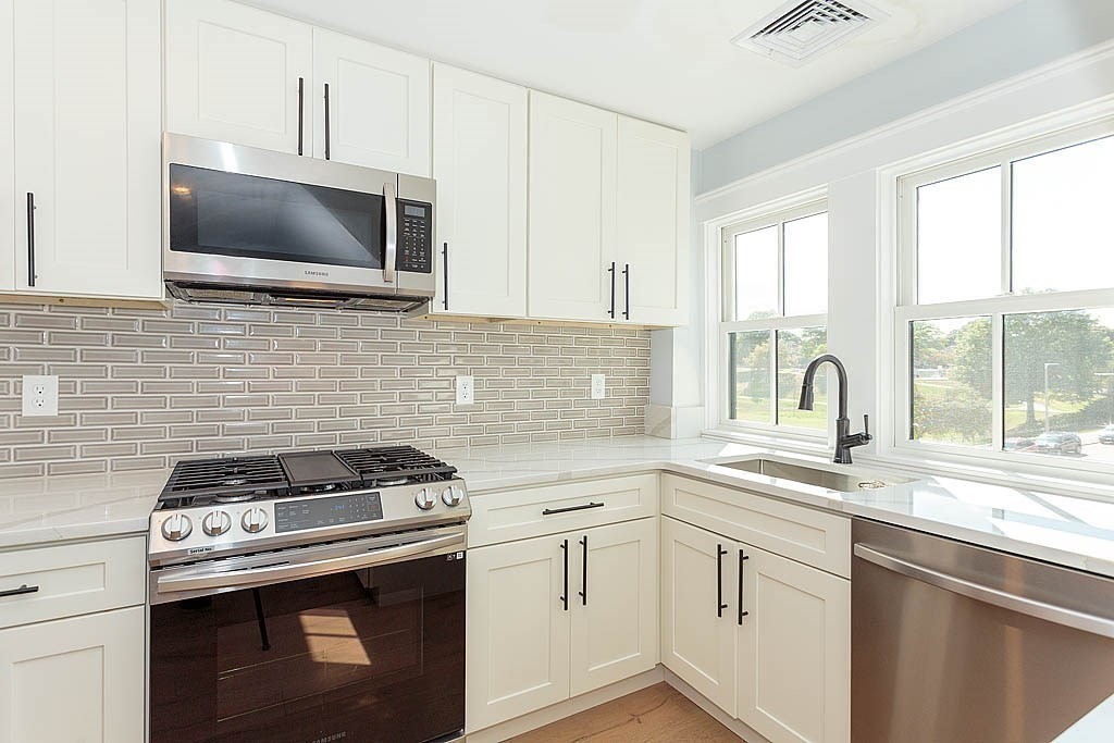 79 Robert Street, Unit 3 Boston, MA 02131 - Photo 2 of 20 a kitchen with granite countertop a stove and a sink