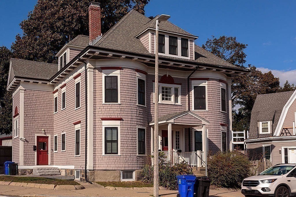 79 Robert Street, Unit 3 Boston, MA 02131 - Photo 9 of 20 a front view of a residential apartment building with a yard