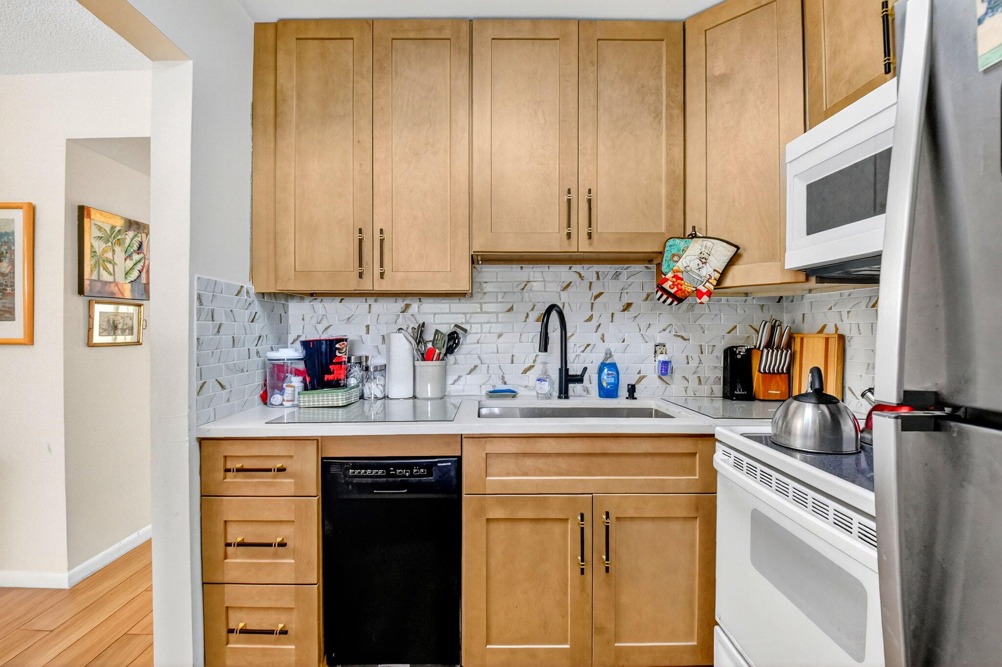 332 Northampton Q West Palm Beach, FL 33417 - Photo 11 of 42 a kitchen with stainless steel appliances granite countertop a refrigerator and sink