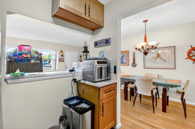 a kitchen with stainless steel appliances granite countertop a stove and a dining table