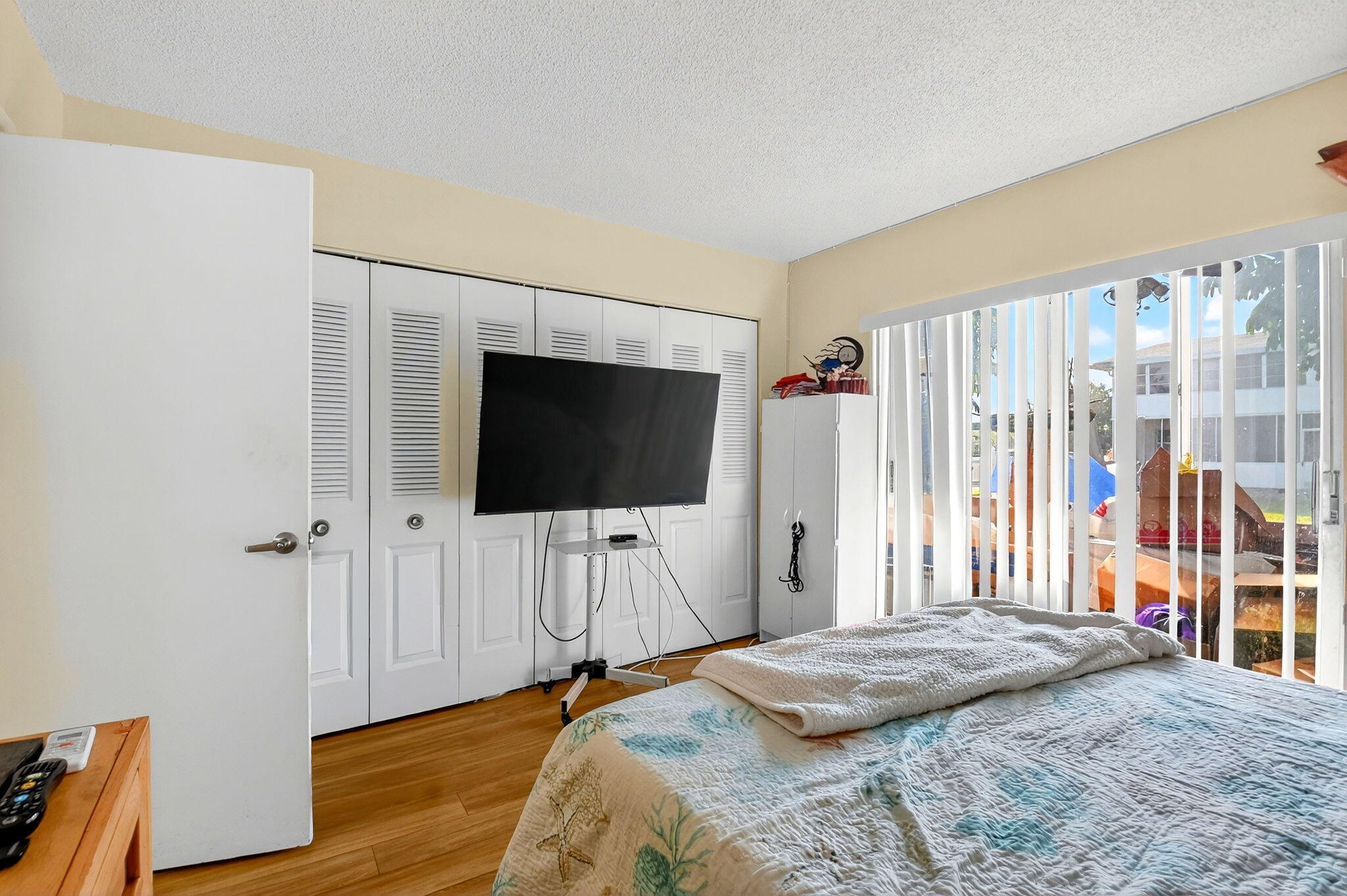 332 Northampton Q West Palm Beach, FL 33417 - Photo 19 of 42 a bedroom with a bed and a flat screen tv