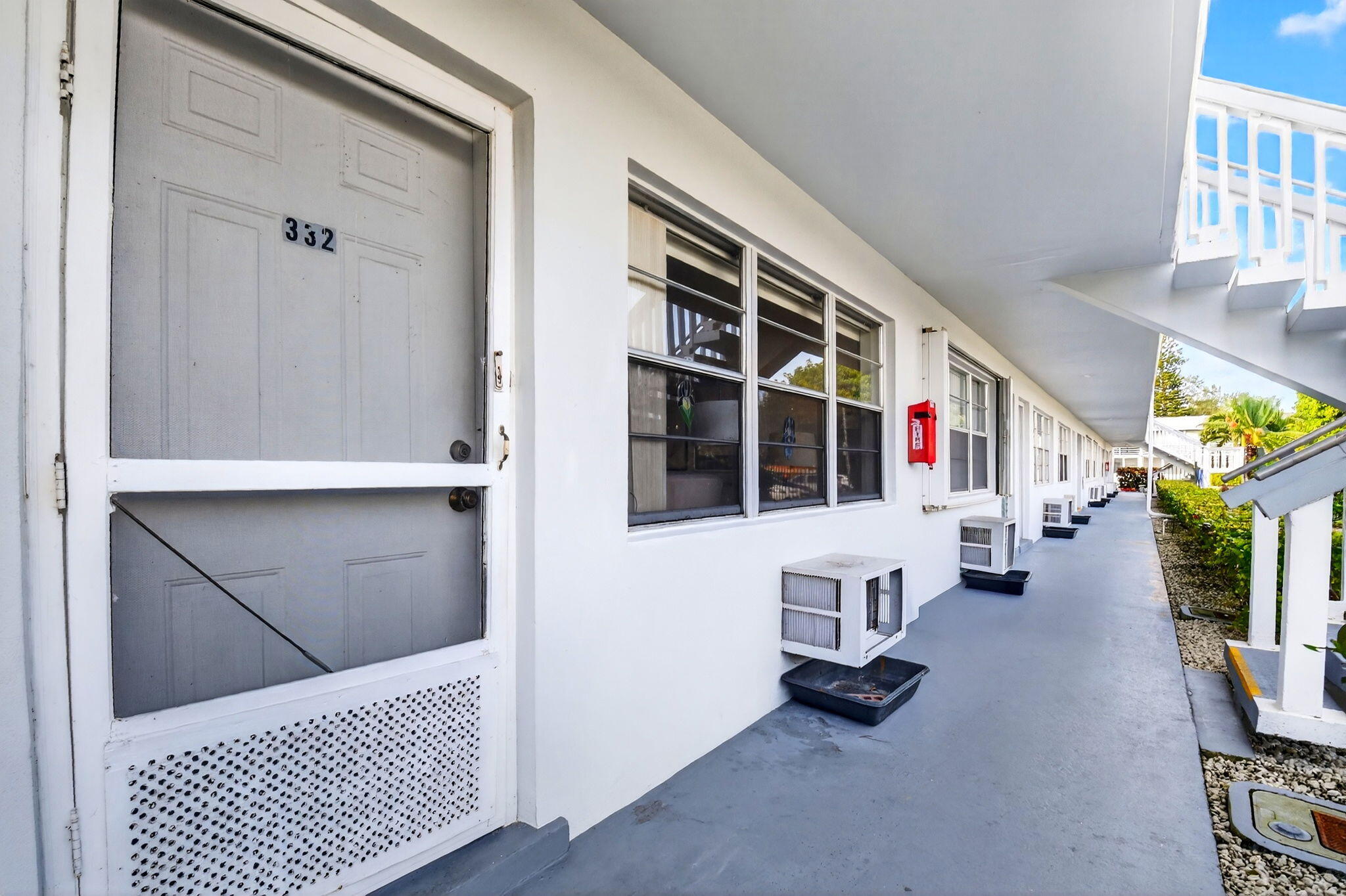 332 Northampton Q West Palm Beach, FL 33417 - Photo 2 of 42 a view of living room kitchen and windows