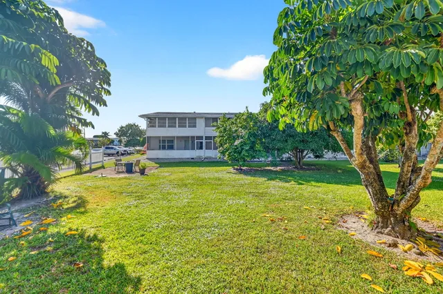 a swimming pool with trees in front of it