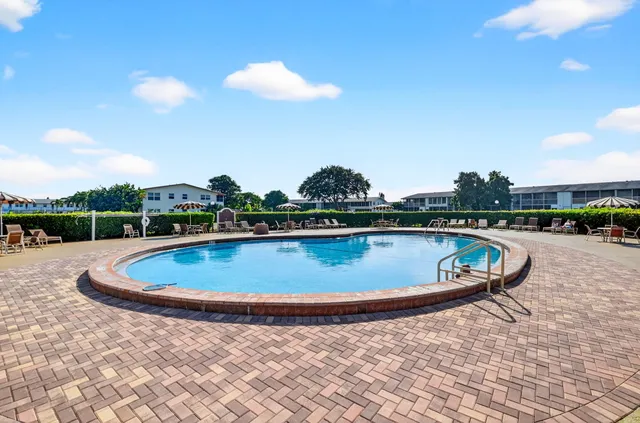 a view of a swimming pool with a yard