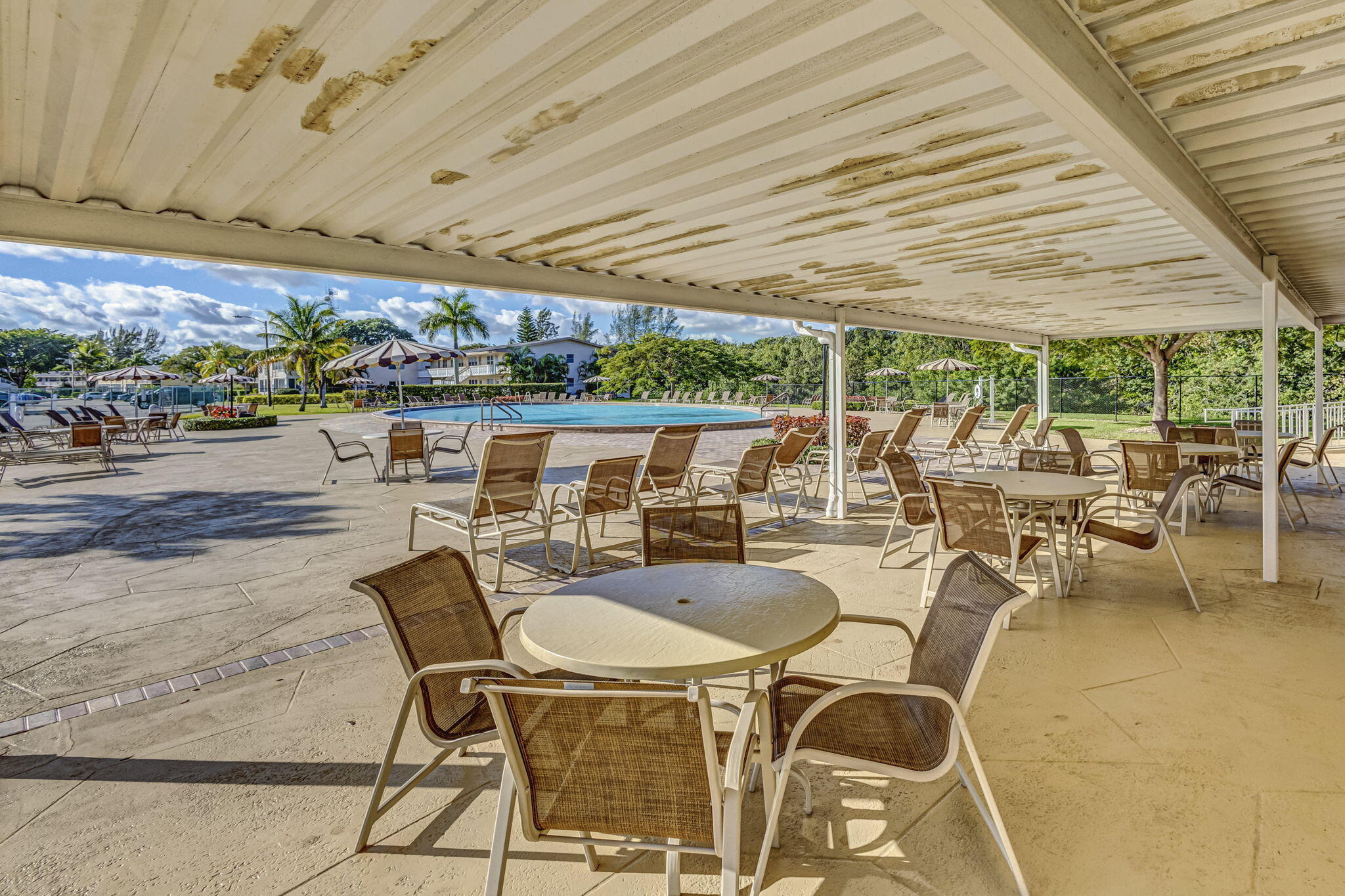 332 Northampton Q West Palm Beach, FL 33417 - Photo 40 of 42 a view of a patio with table and chairs and potted plants