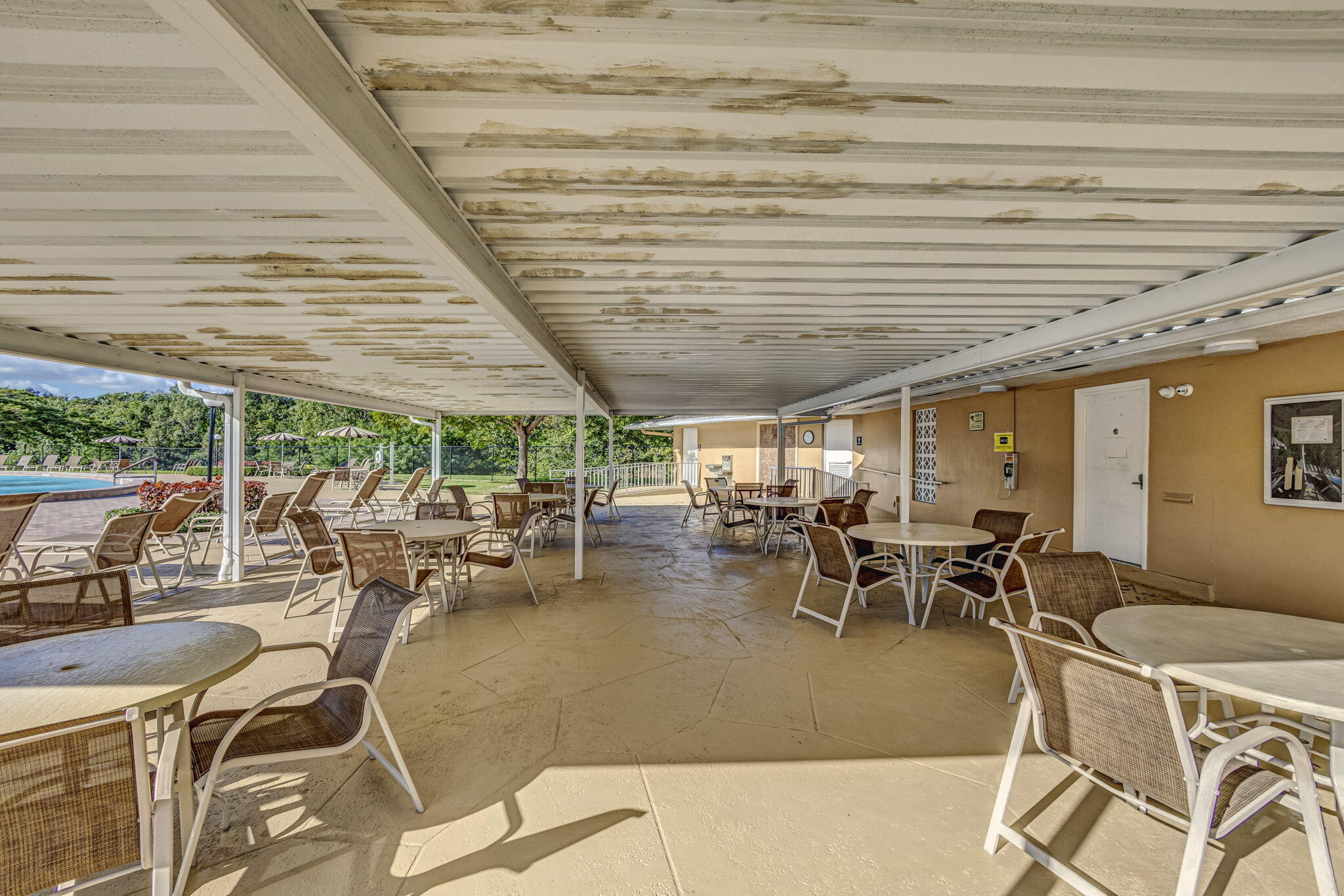 332 Northampton Q West Palm Beach, FL 33417 - Photo 41 of 42 a outdoor space with lots of tables a garden view and chairs