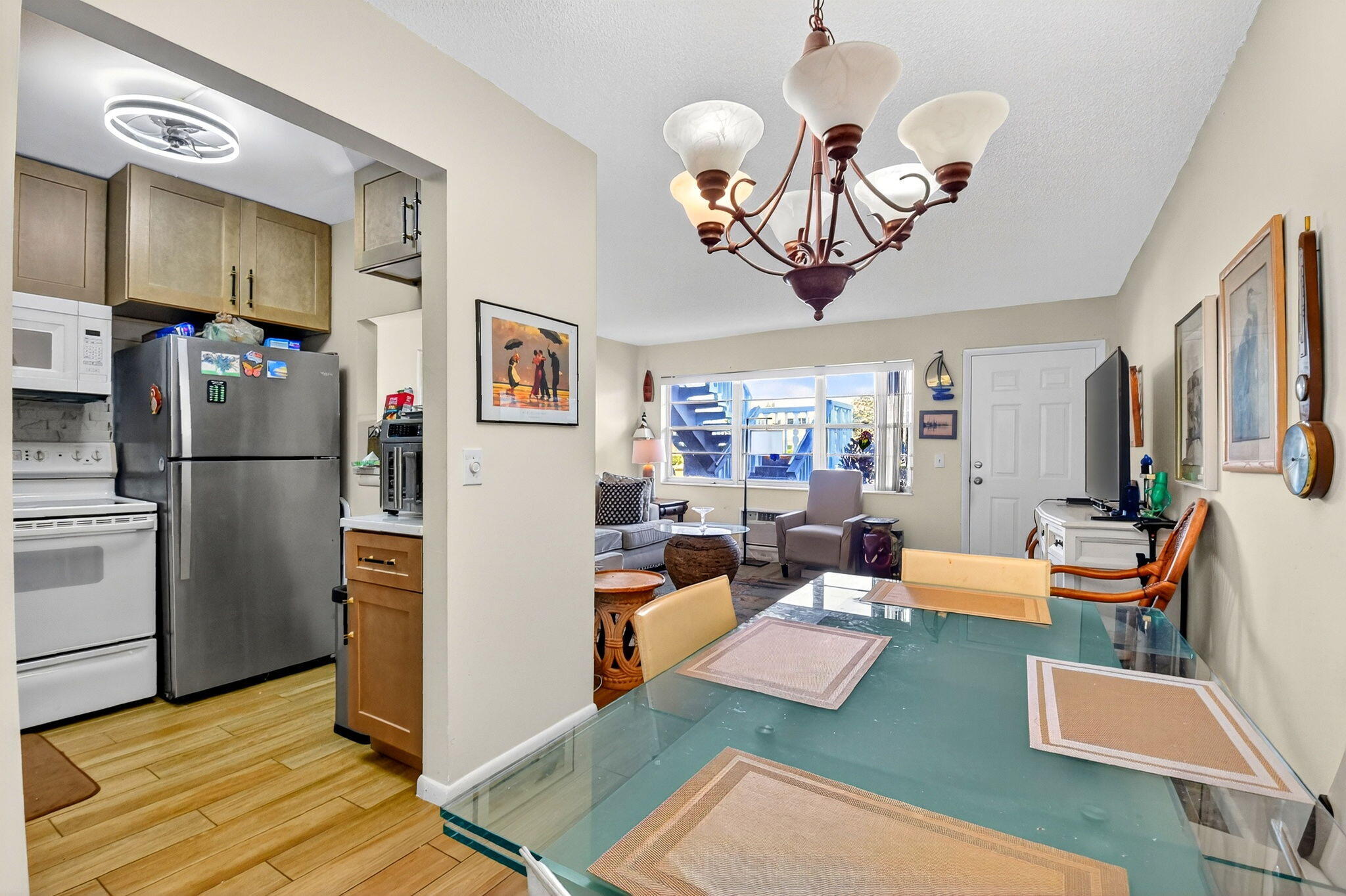 332 Northampton Q West Palm Beach, FL 33417 - Photo 8 of 42 a living room with furniture kitchen view and a refrigerator