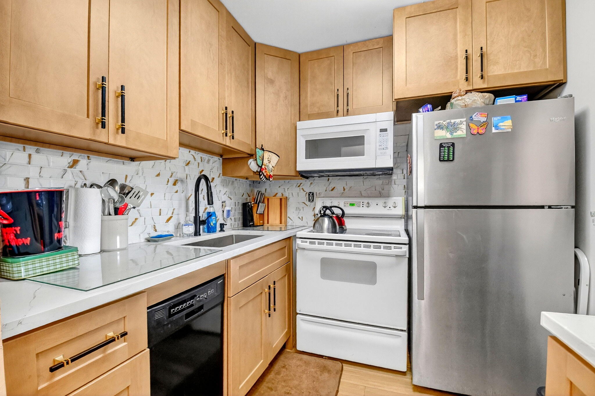 332 Northampton Q West Palm Beach, FL 33417 - Photo 9 of 42 a kitchen with stainless steel appliances granite countertop a refrigerator sink and cabinets