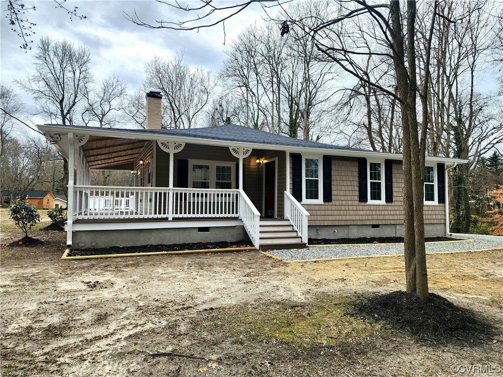 a view of a house with a yard in the background