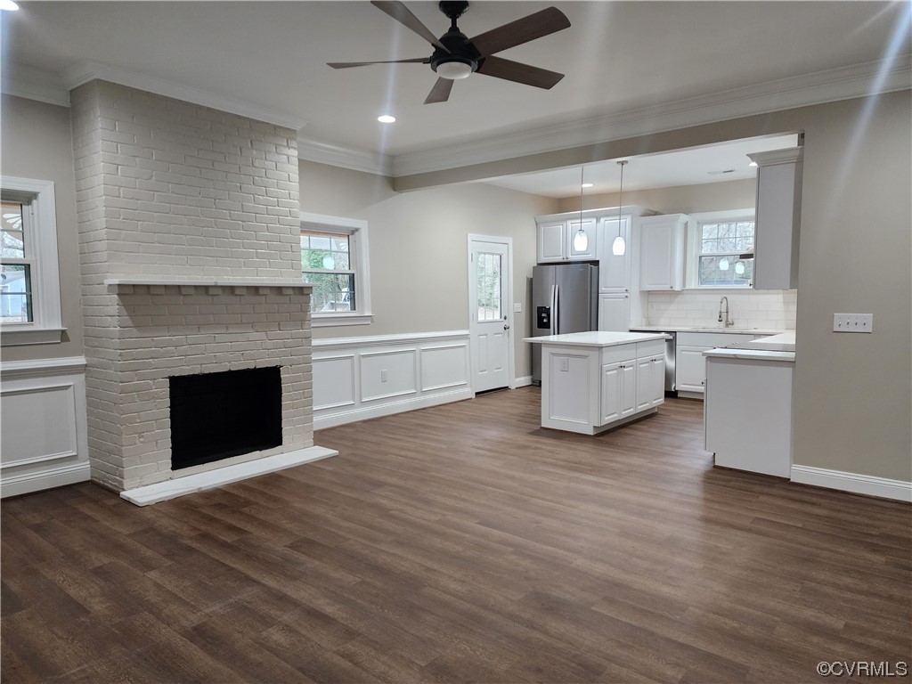 2813 Parkdale Road North Chesterfield, VA 23234 - Photo 10 of 36 a living room with a fireplace cabinet and a ceiling fan