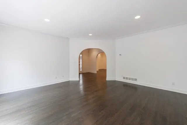 a view of a room with wooden floor and window