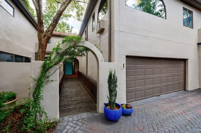 a house with potted plants in front of door