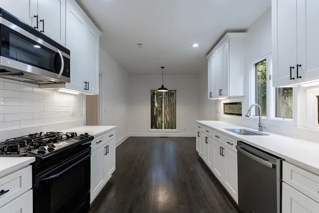 a window in an empty room with wooden floor