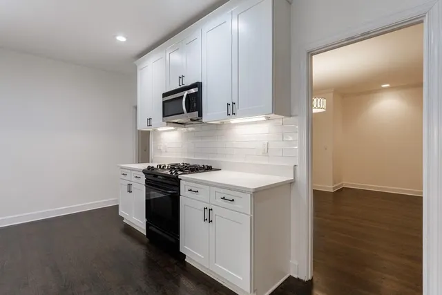 a kitchen with stainless steel appliances granite countertop a sink stove oven and refrigerator