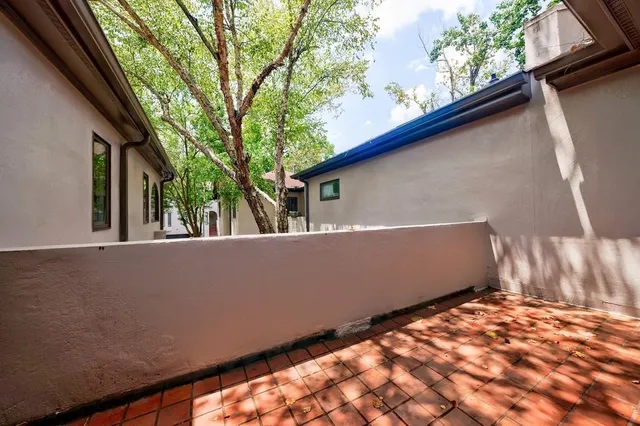 an empty room with fan and entrance