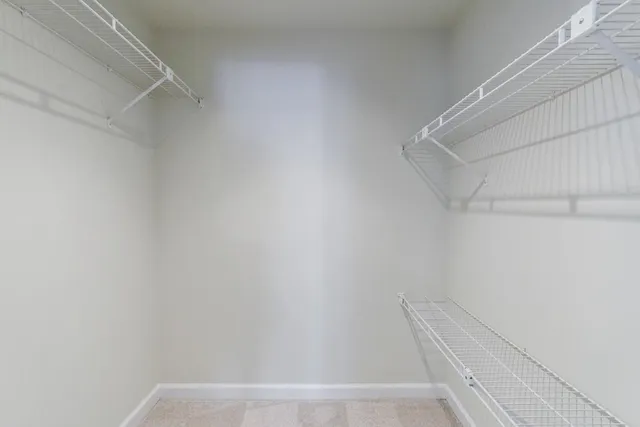 an empty room with a fireplace and mirror