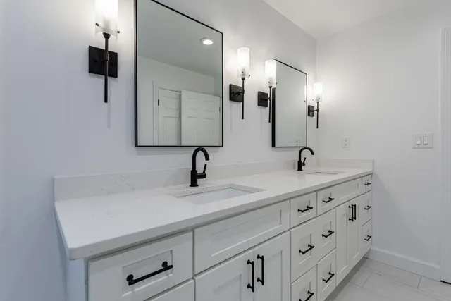 a view of an empty room with a fireplace and a window