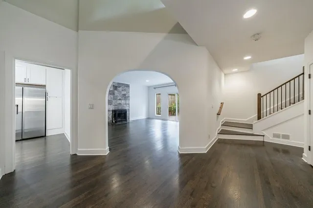 a view of a hallway view with wooden floor and staircase