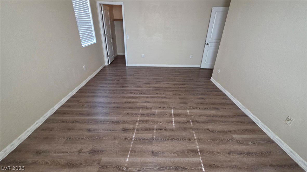 6977 Florido Road Las Vegas, NV 89178 - Photo 15 of 22 Laminate flooring extends throughout this naturally illuminated, spacious room, offering versatile living options.