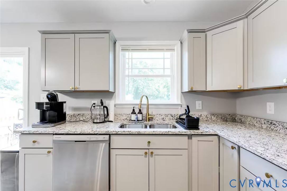 711 Jackson Street Colonial Beach, VA 22443 - Photo 19 of 41 a kitchen with sink cabinets and window