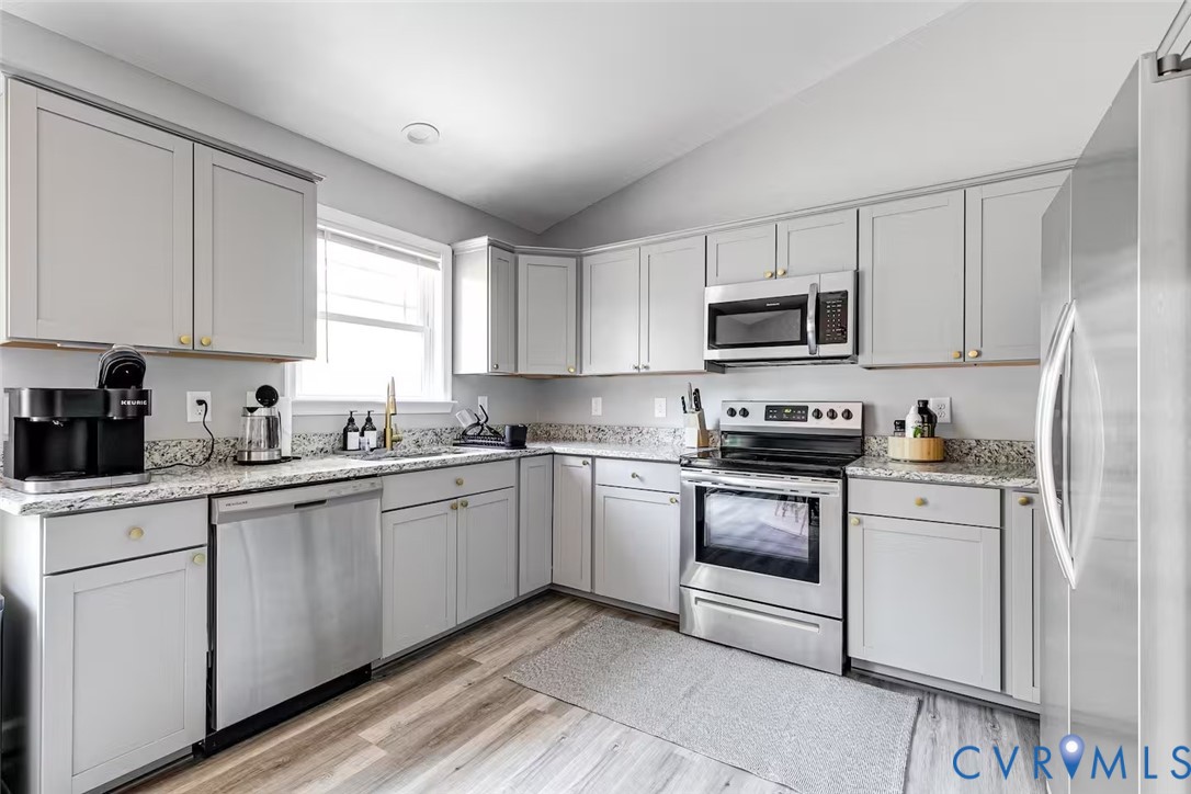 711 Jackson Street Colonial Beach, VA 22443 - Photo 22 of 41 a kitchen with cabinets stainless steel appliances and a window
