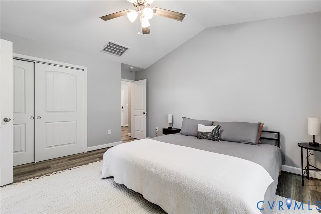 711 Jackson Street Colonial Beach, VA 22443 - Photo 23 of 41 a bedroom with a bed and a chandelier