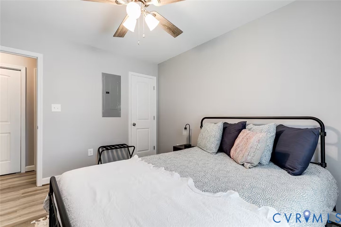 711 Jackson Street Colonial Beach, VA 22443 - Photo 24 of 41 a bedroom with a bed and wooden floor