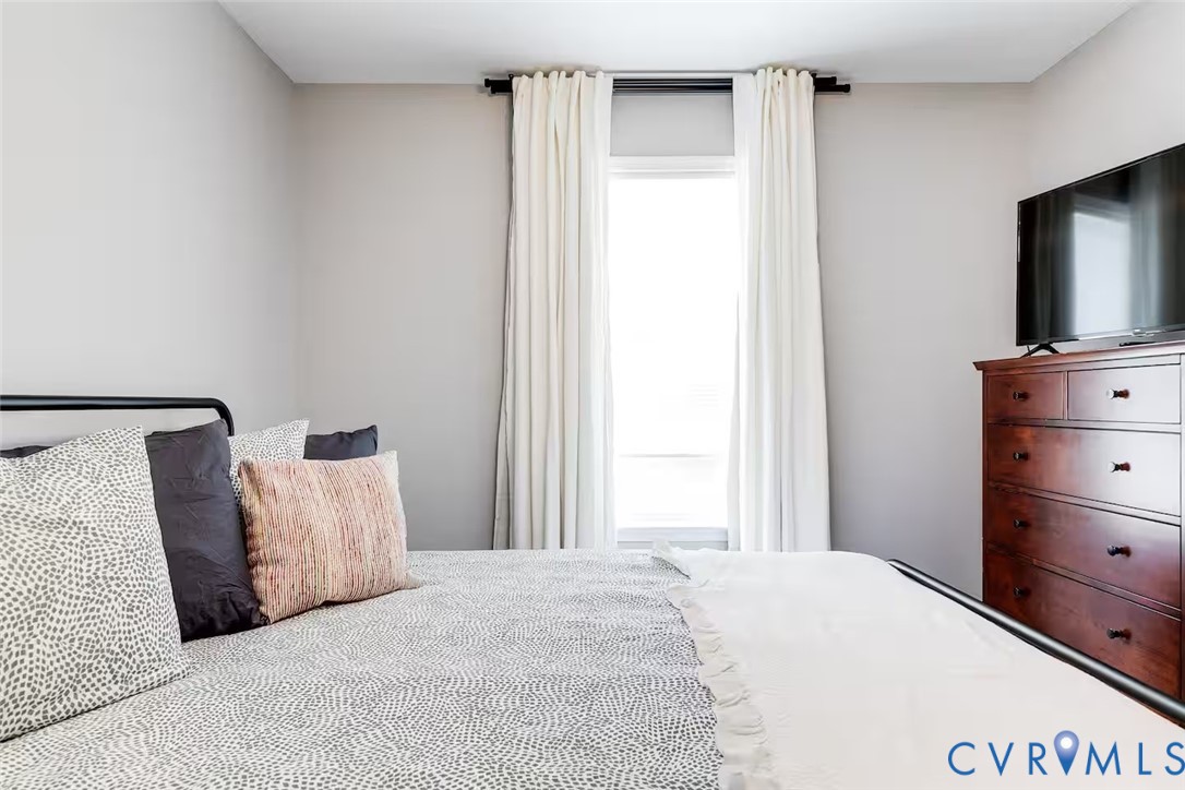 711 Jackson Street Colonial Beach, VA 22443 - Photo 25 of 41 a bedroom with a bed and a flat tv screen in it