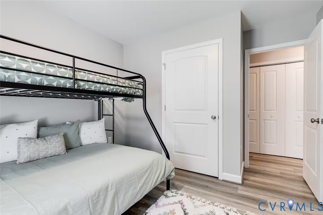 711 Jackson Street Colonial Beach, VA 22443 - Photo 31 of 41 a bedroom with a bed and wooden floor