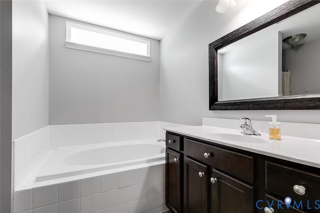 711 Jackson Street Colonial Beach, VA 22443 - Photo 33 of 41 a bathroom with a bathtub sink vanity and mirror