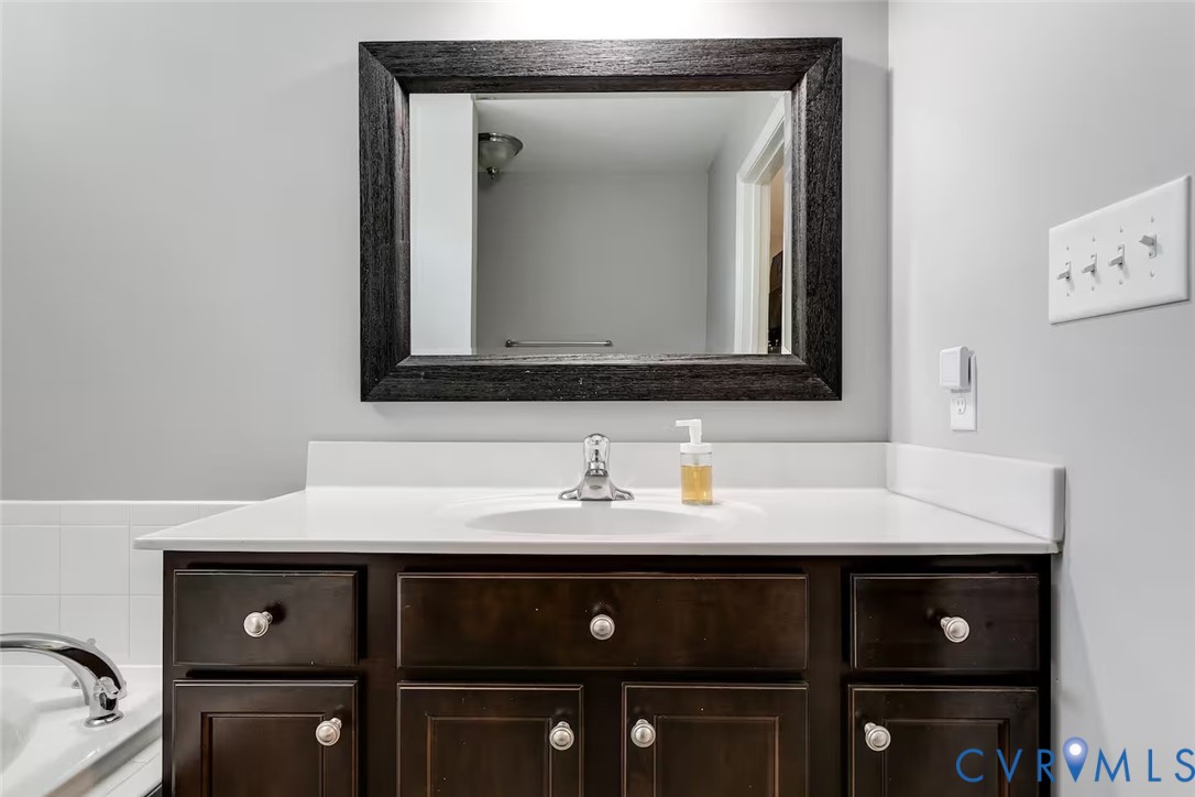 711 Jackson Street Colonial Beach, VA 22443 - Photo 36 of 41 a bathroom with a sink and a mirror