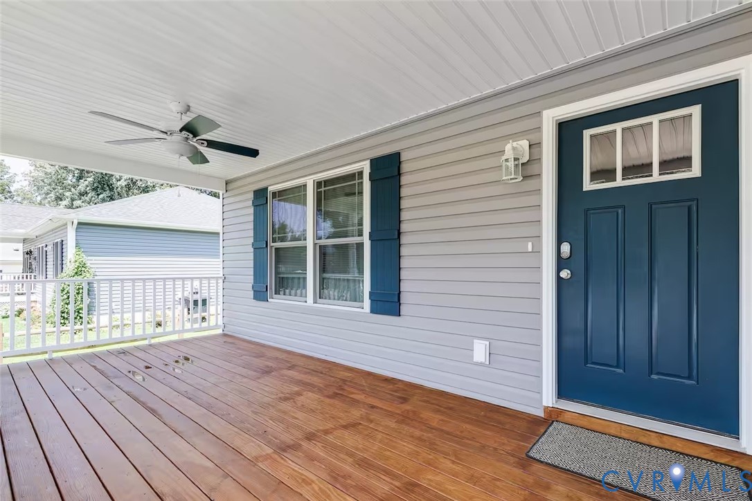 711 Jackson Street Colonial Beach, VA 22443 - Photo 5 of 41 a view of an empty room with a window and wooden floor