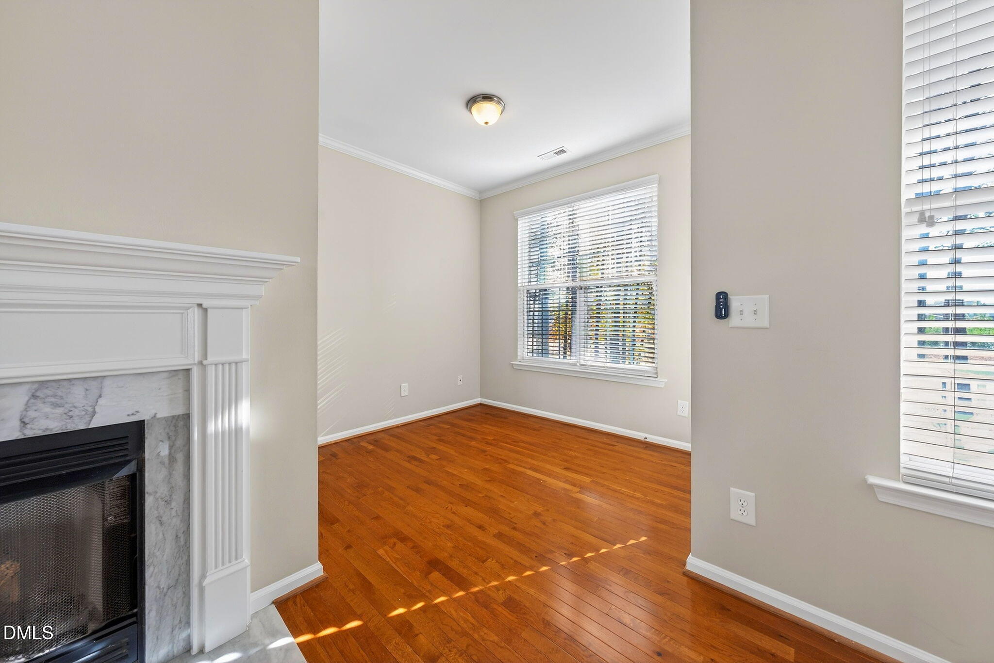 4523 Pale Moss Drive Raleigh, NC 27606 - Photo 27 of 42 a view of an empty room with a fireplace and a window