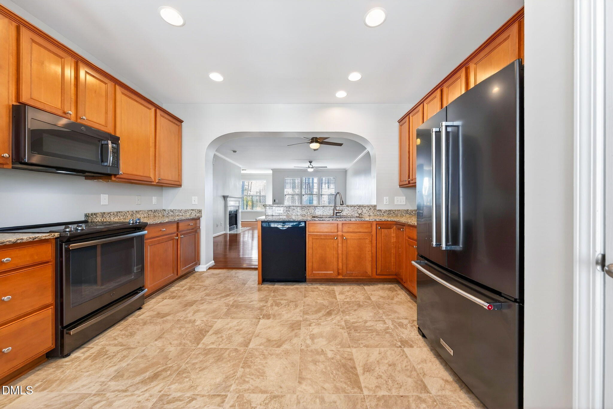 4523 Pale Moss Drive Raleigh, NC 27606 - Photo 5 of 42 a large kitchen with stainless steel appliances granite countertop a stove a sink dishwasher a refrigerator and a microwave oven